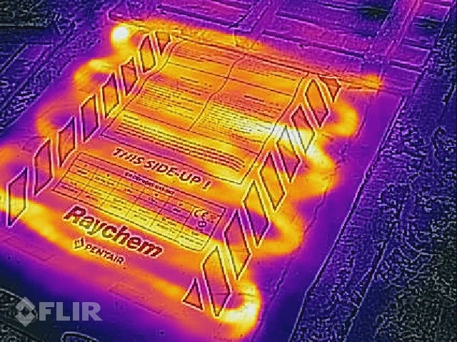 Termowizja przenośnej maty grzewczej, widać ciepłe przewody grzejne podczas pracy.